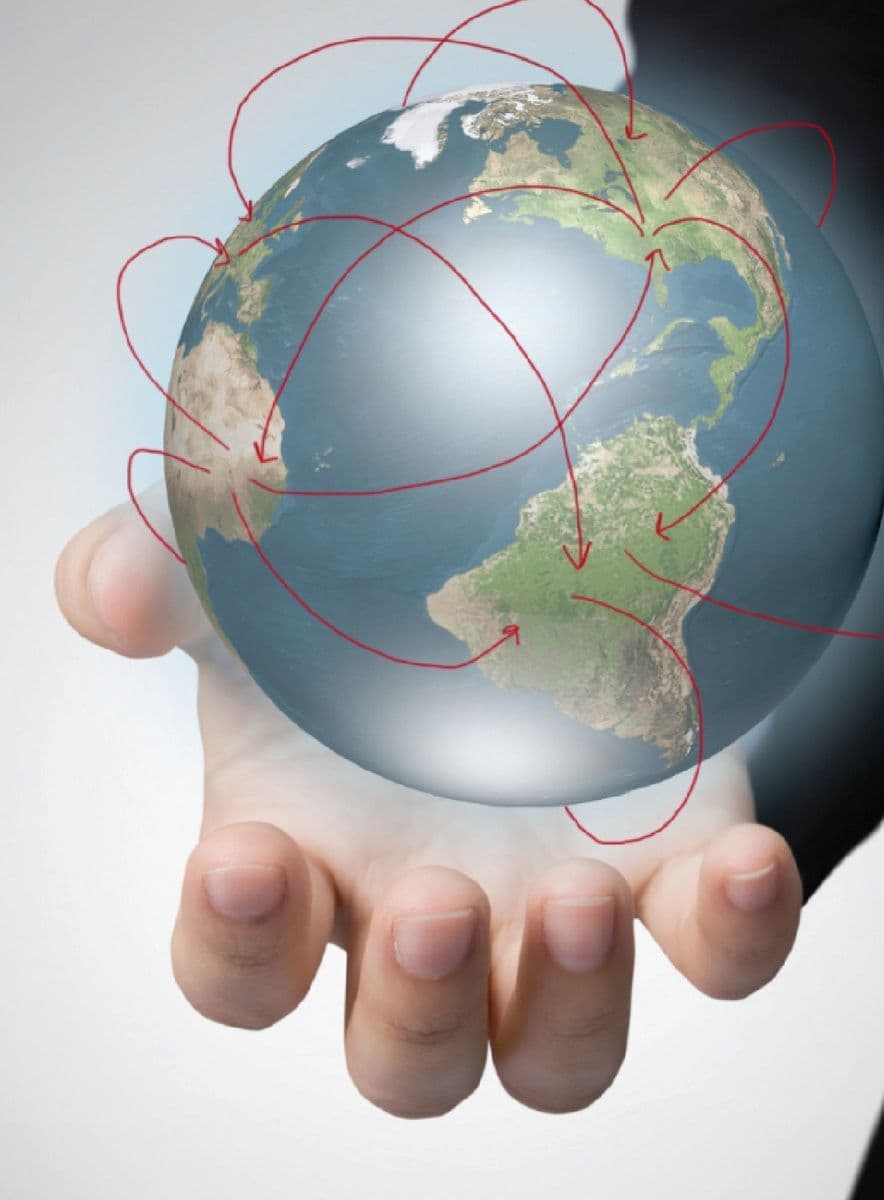 Hand holding a globe representing global sourcing networks